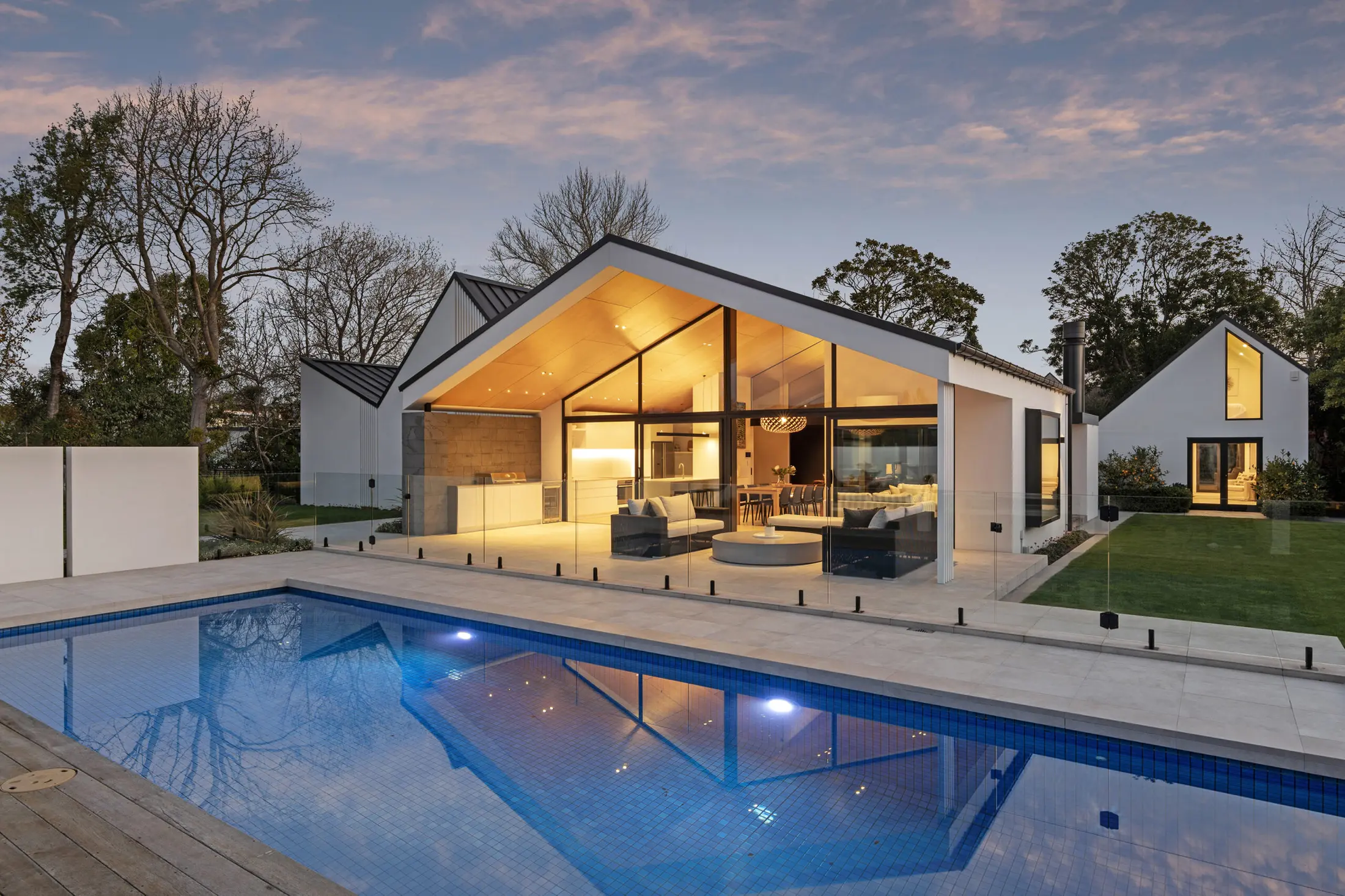 21A Hamilton Avenue illuminated at dusk beside the swimming pool