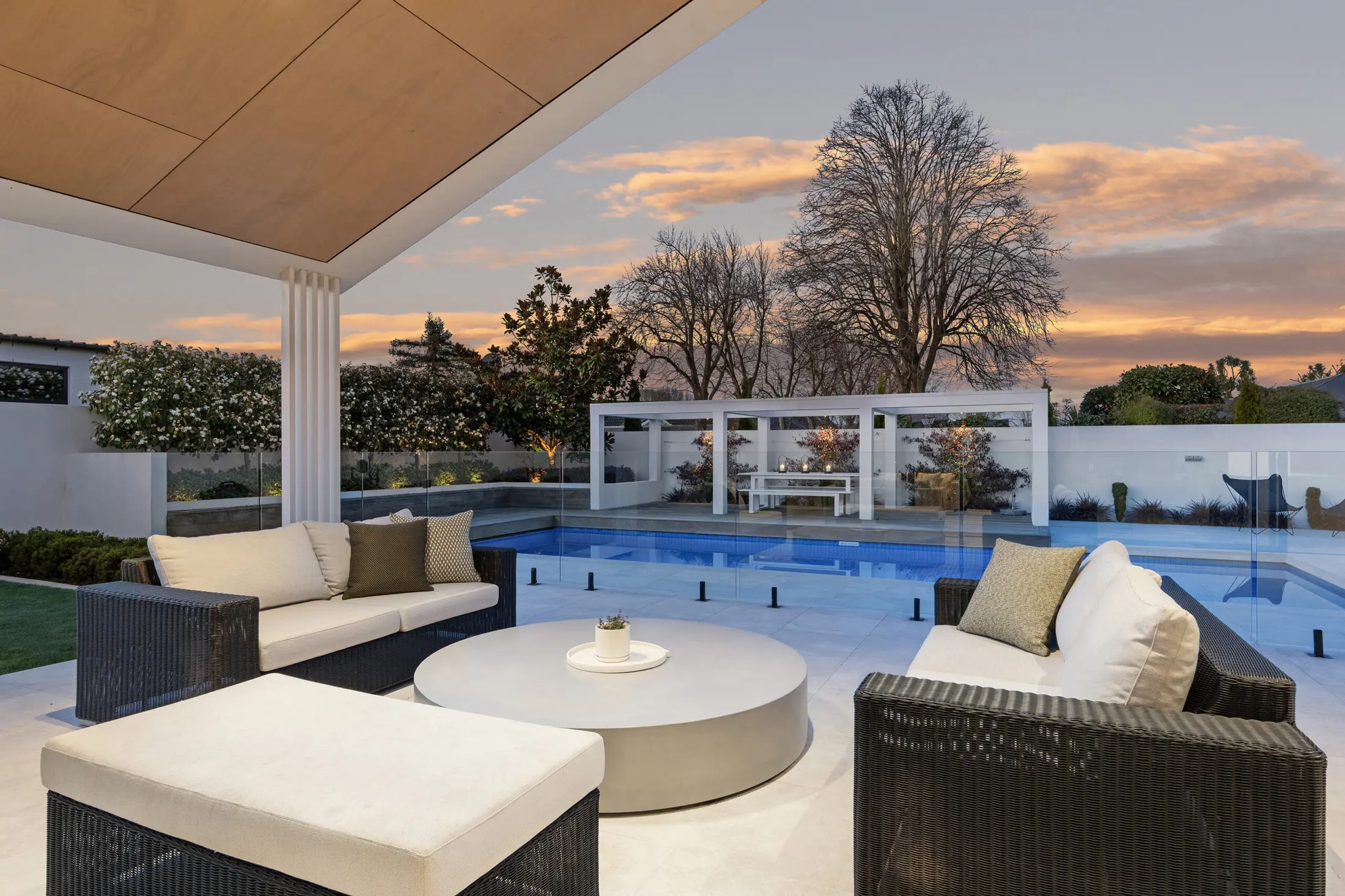 Covered poolside terrace at sunset